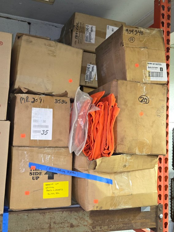 Lot Welding Pants & Jackets - On Pallet Racking Near Scrap Wood