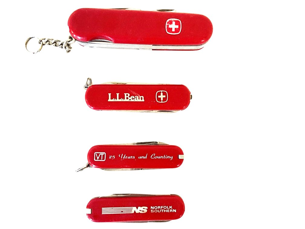 Four Red Swiss Army-Style Pocket Knives
