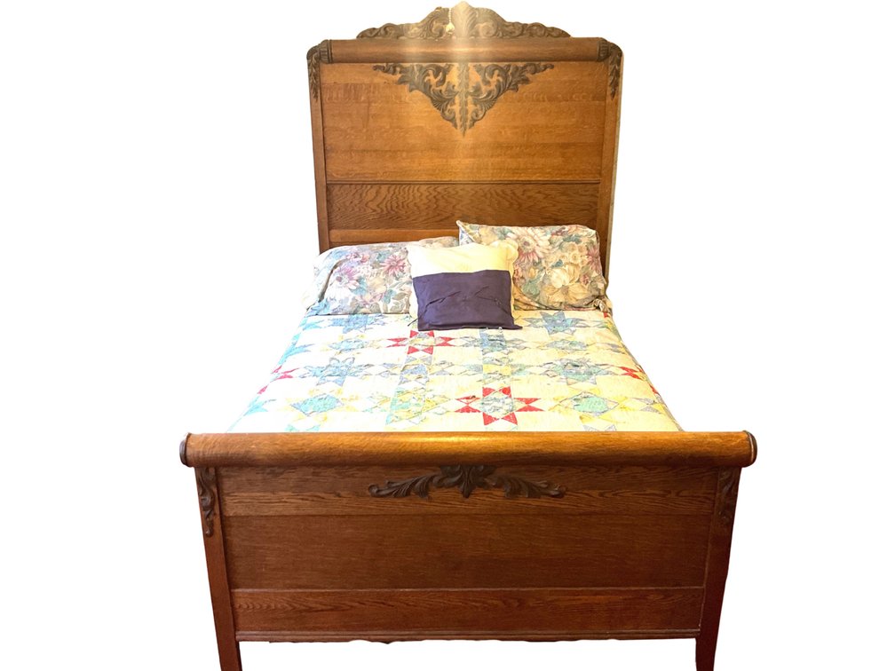 Full-Size Ornate Carved Wood Bed with Patchwork Quilt