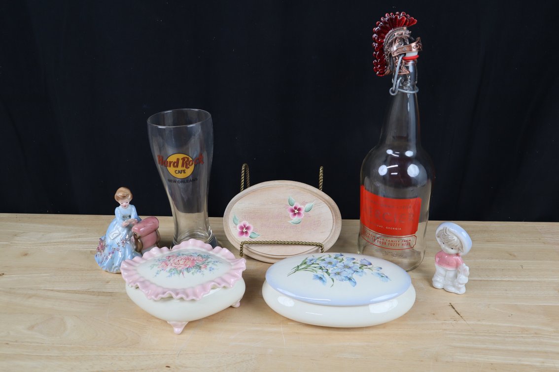 Assortment of Collectibles Including (2) Ceramic Covered Jewelry Boxes, (1) Mercier Hard Cider Bottles (1) Roman Style Helmet Bottle Topper, and More!