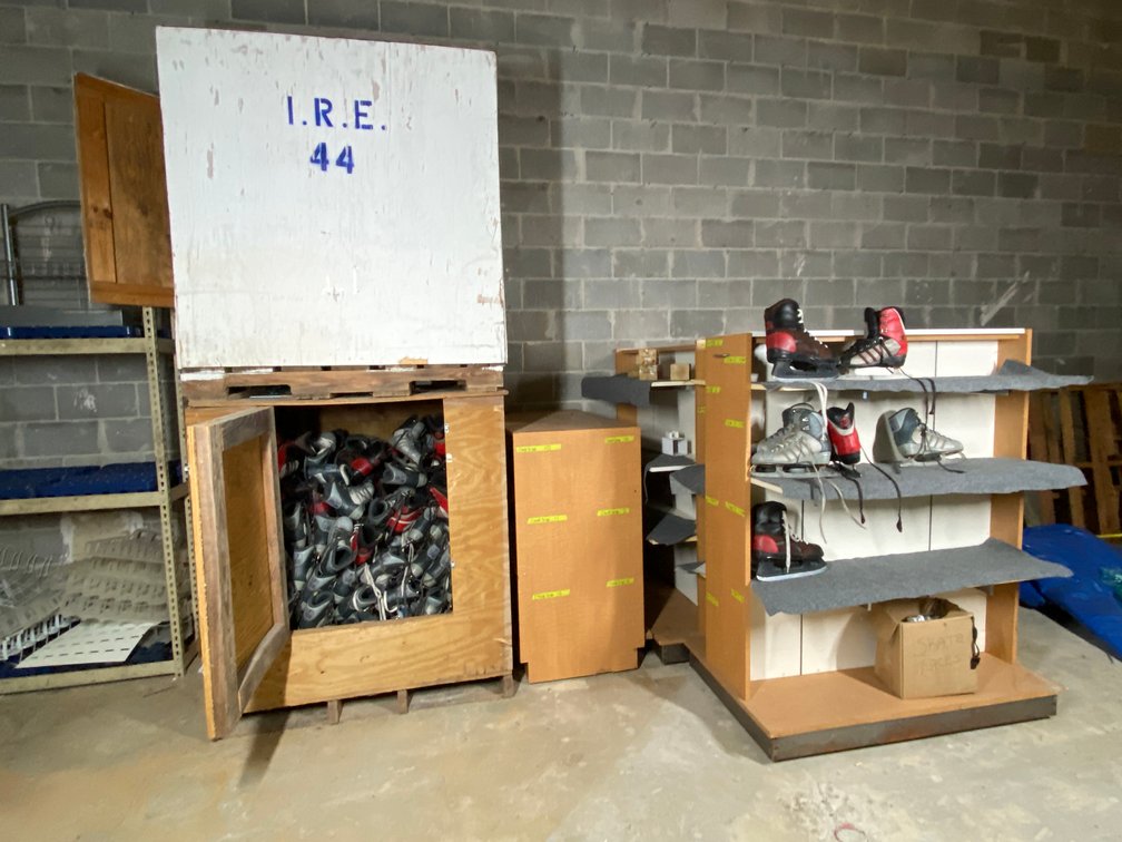 (2) Ice Skating Crates Filled with Ice Skates and (4) Carpeted Shelving Units for Storing Rental Skates