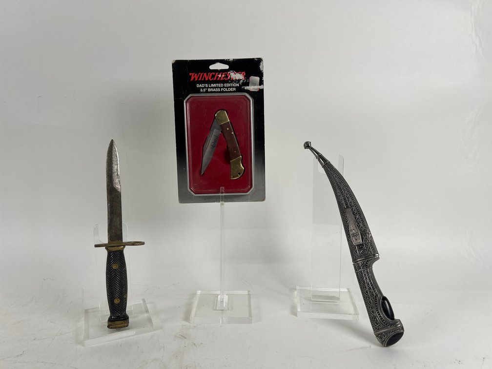 (1) WW II Era U.S. M7 Bayonet with a Gold Painted Handle, (1) Winchester Dead's Limited Edition Pocket Knife, & (1) Curved Stanless Steel Dagger with an Ornate Silver Colored Metal Handle and Scabbard