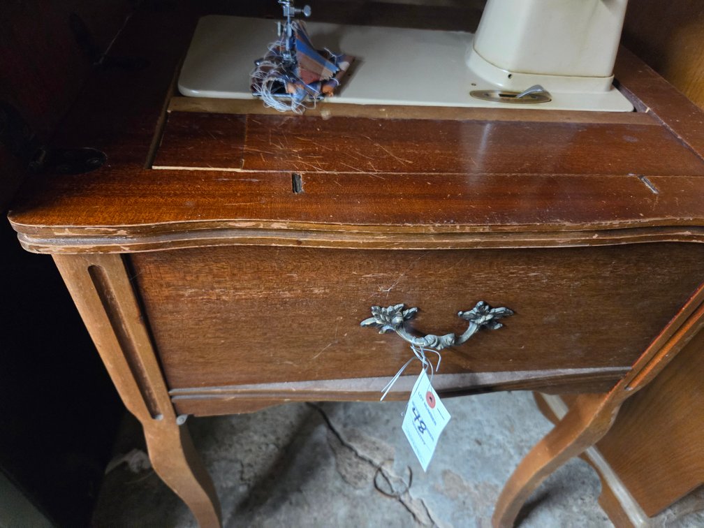 Singer sewing machine in a cabinet