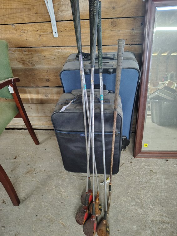 Travel luggage and assorted golf clubs