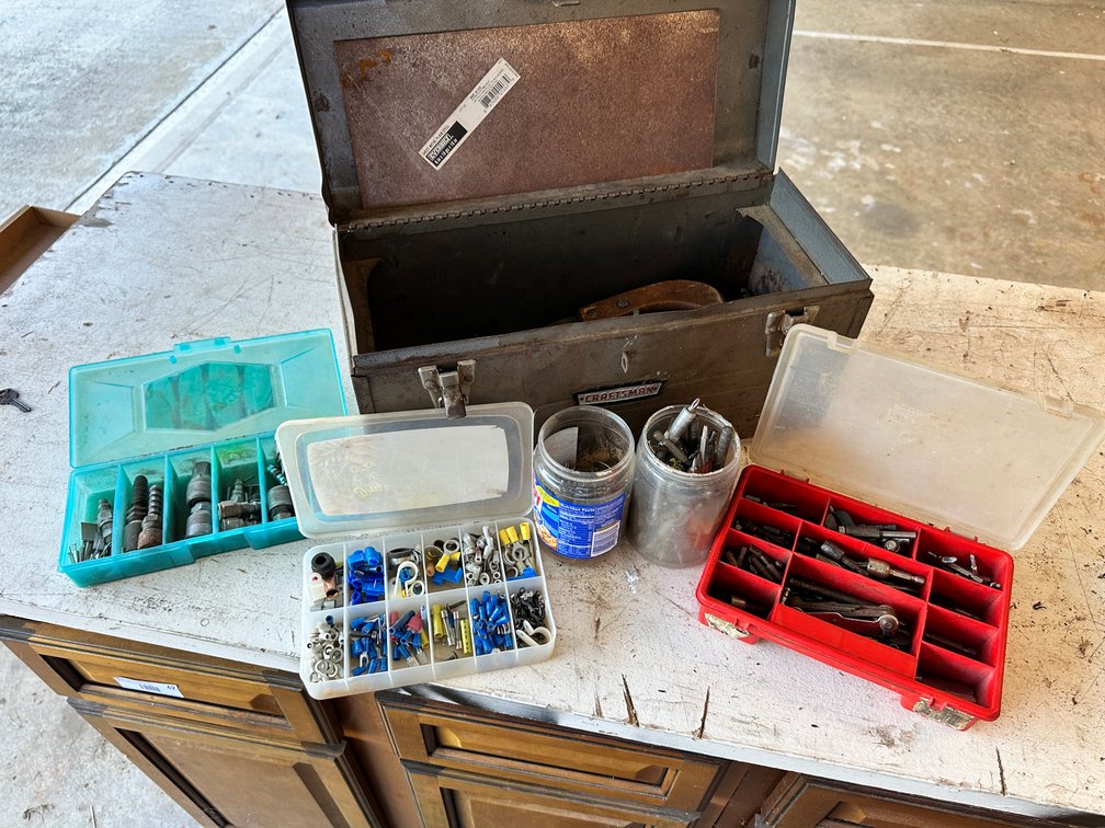 Metal toolbox with drill bits and assorted items