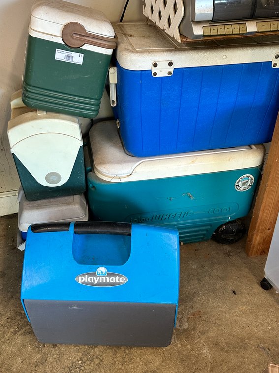 Assorted coolers and plastic storage container on wheels