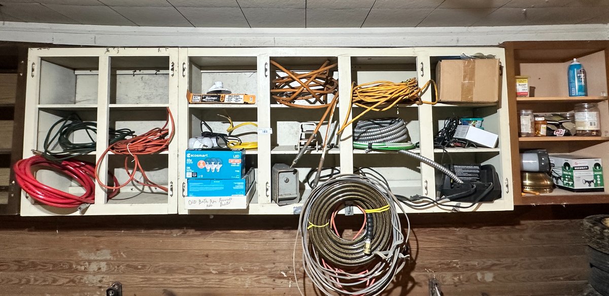 Shelf Contents- Extension cords, light bulbs, 300psi air hose, battery charger