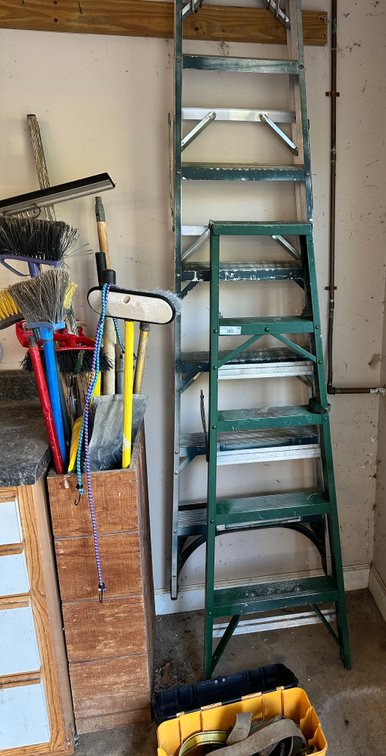 2 Ladders, straps and assorted brooms