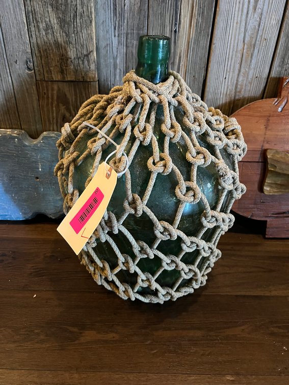 Glass jug with rope netting