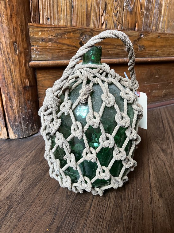 Glass jug with rope netting