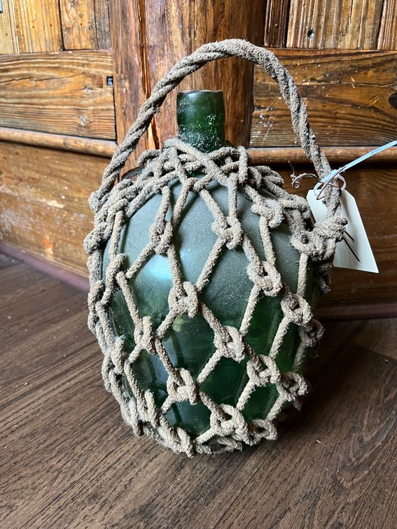 Glass jug with rope netting