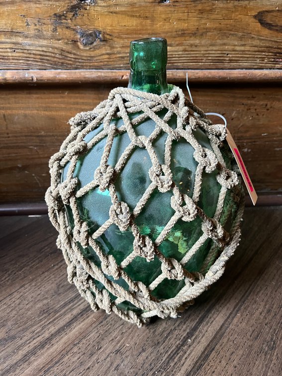 Glass jug with rope netting