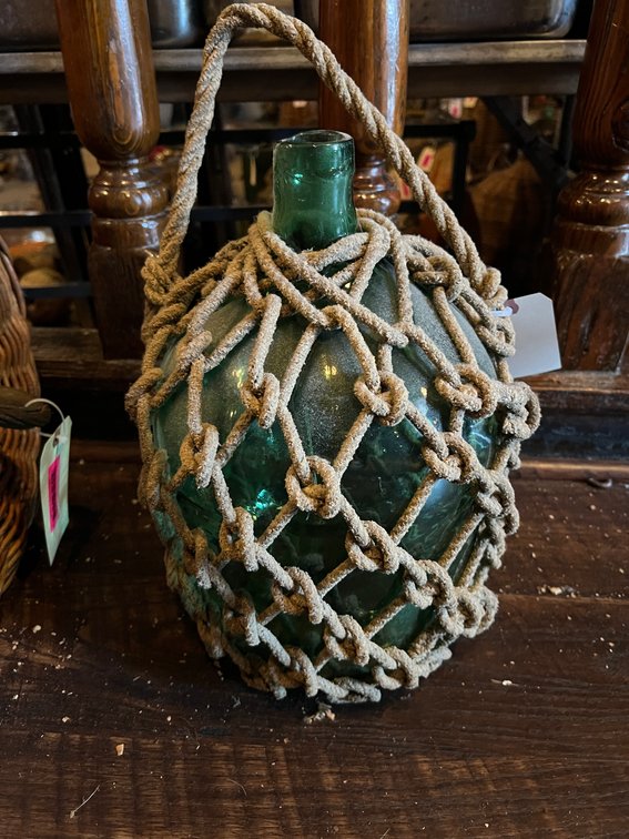 Glass jug with rope netting