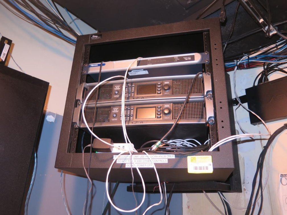 Wall Mounted AV Cabinet with Contents, 2 QSC CXD 4.3 4 Channel Processing Amp, Symetrix 761 Integrated Series Zone Mix