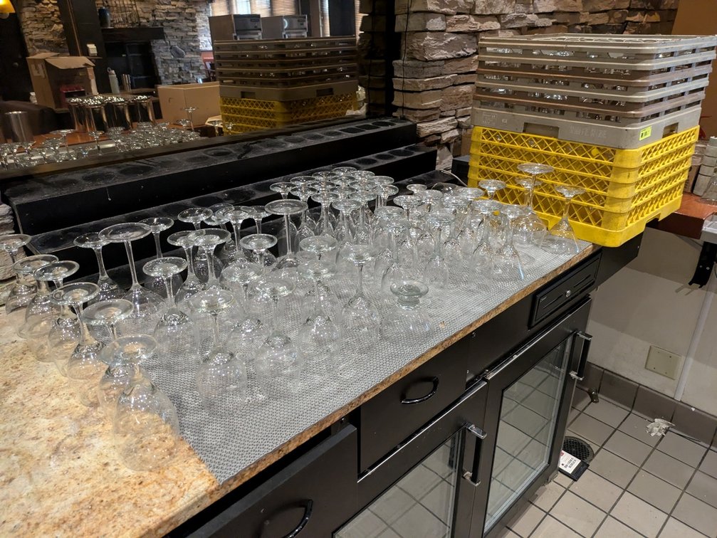 Assorted Glassware and Drying Racks Behind Bar