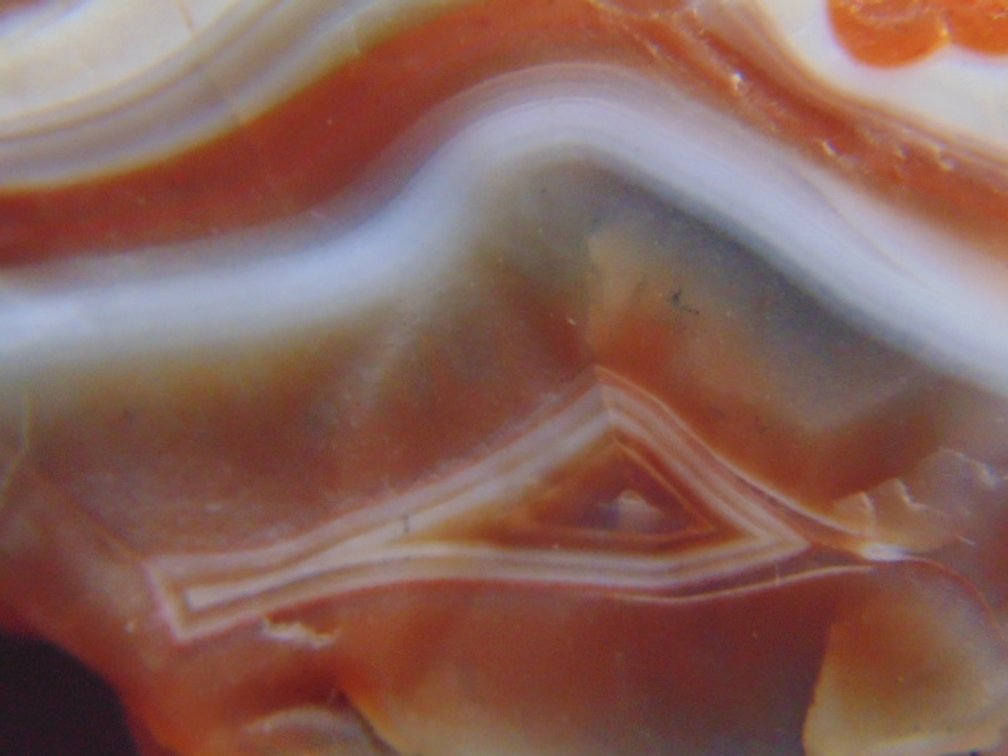 A 1 oz Lake Superior Agate that is full of bright bold banding