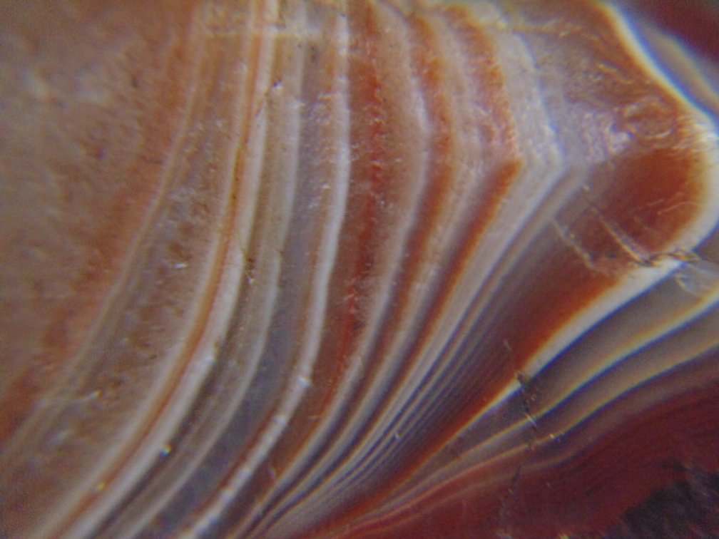 A 1.3 oz Lake Superior Agate with nice red and white banding around a pocket of quartz
