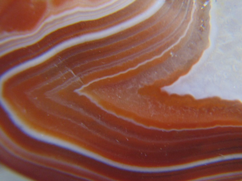 A .7 oz Lake Superior Agate with a nice banding around a pocket of quartz and with a satin finish