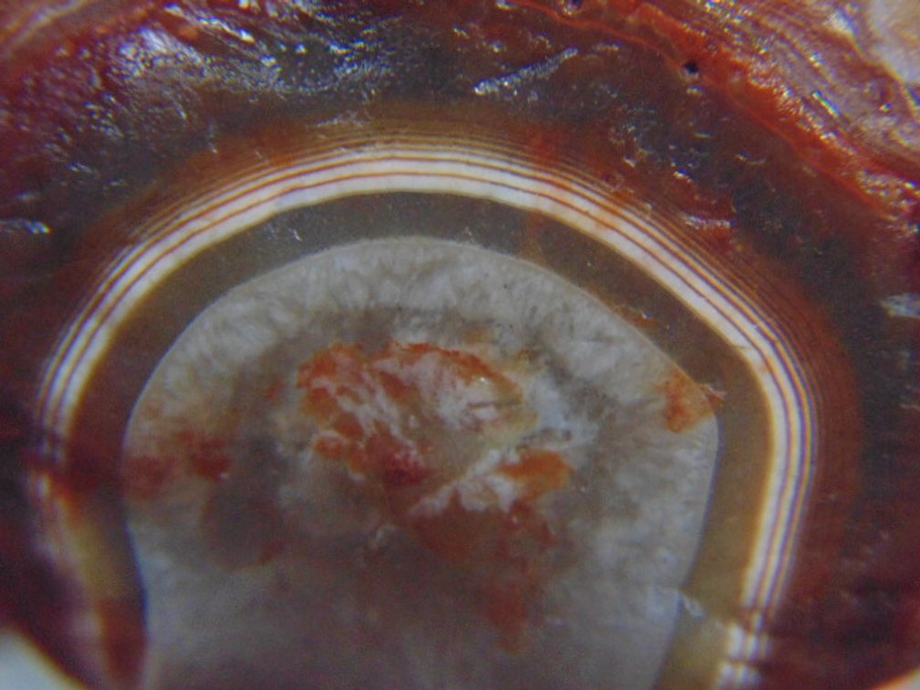 A 2.1 oz Lake Superior Agate with nice banding around a pocket of quartz along with a few eyes