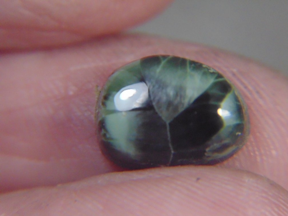A face polished Greenstone cab, .5 grams