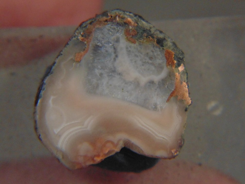 A face polished Copper Replacement Agate on a acrylic stand from Wolverine Mine, 18 grams