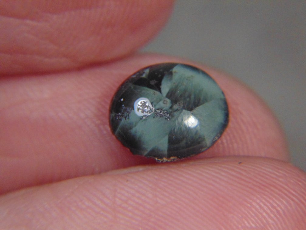 A face polished Greenstone cab, .3 grams