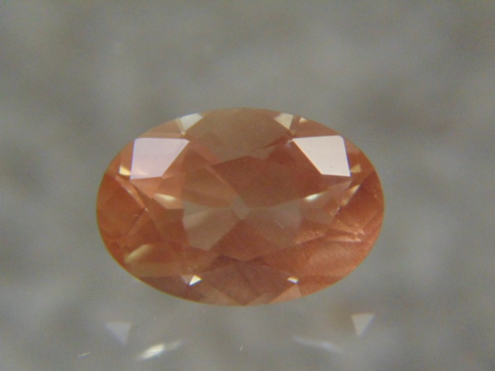 A oval faceted stone possibly Sunstone