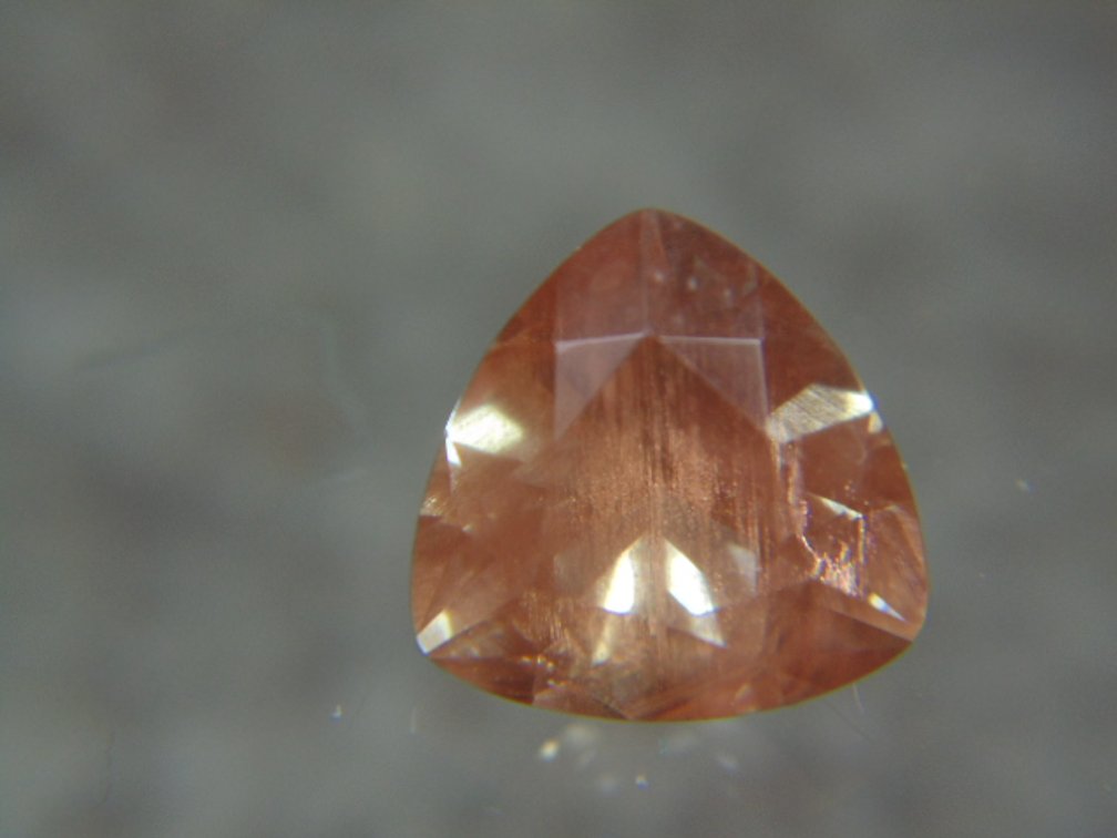 A trillion cut faceted stone possibly Sunstone