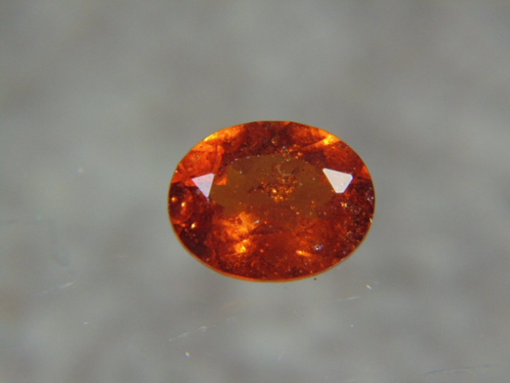 A oval faceted stone possibly Garnet