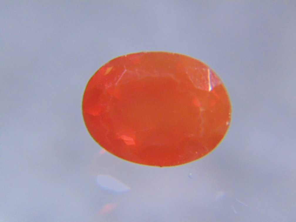 A orange oval faceted stone