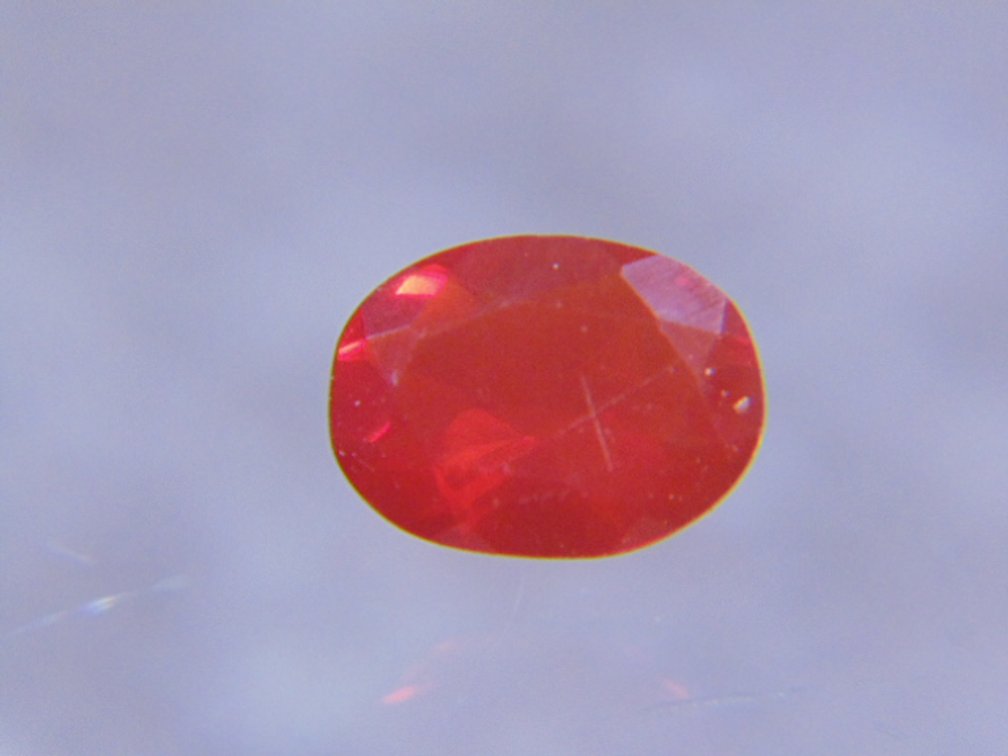 A orange oval faceted stone