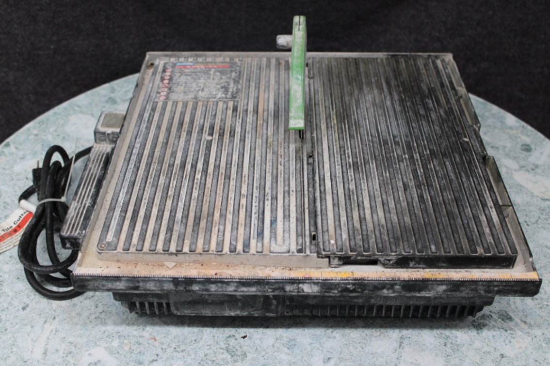 A used tile saw with a 4" blade, half of the deck is removable for easy cleaning