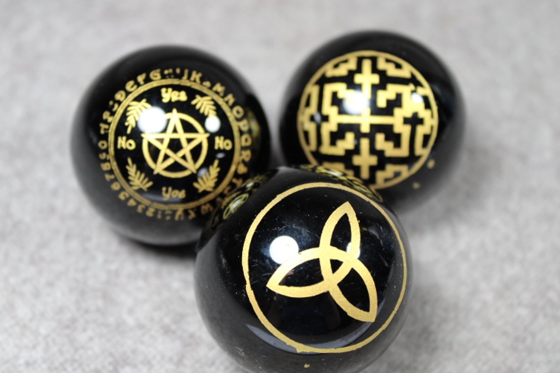 Three spheres with Wiccan symbols