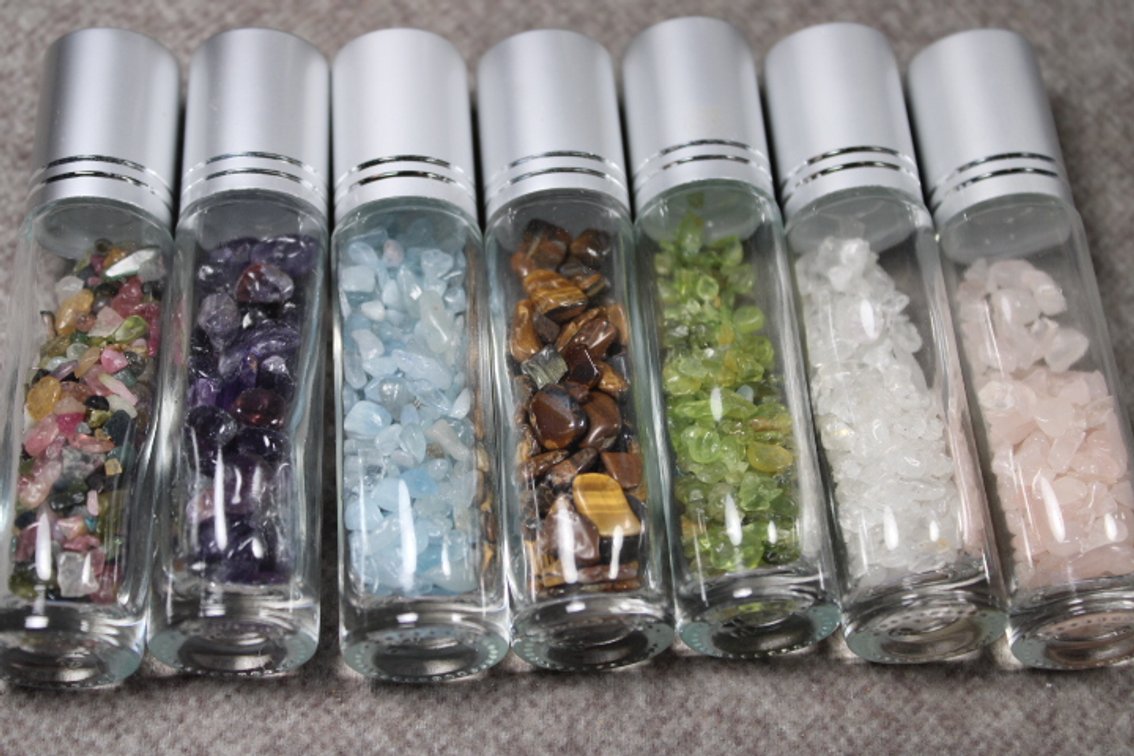 Twenty five Essential Oil roll ons with assorted gemstone chips