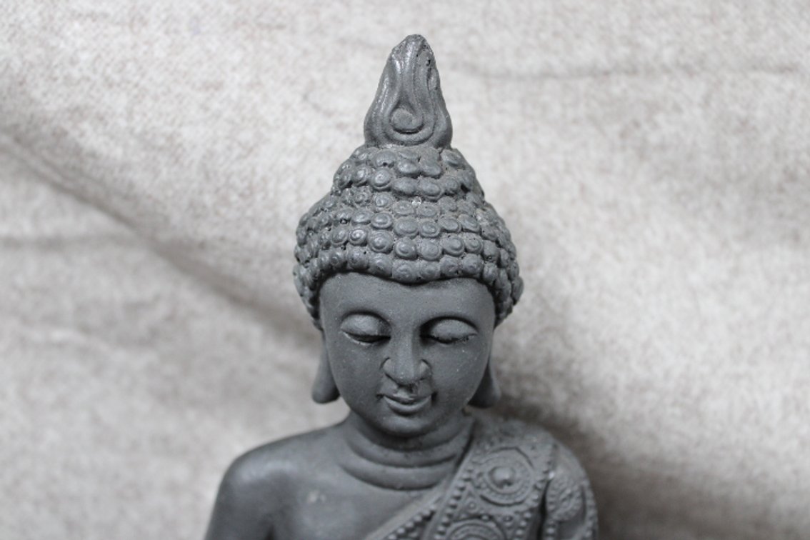 A Buddha statue measuring approximately 9 3/4" high by 6 1/4" wide