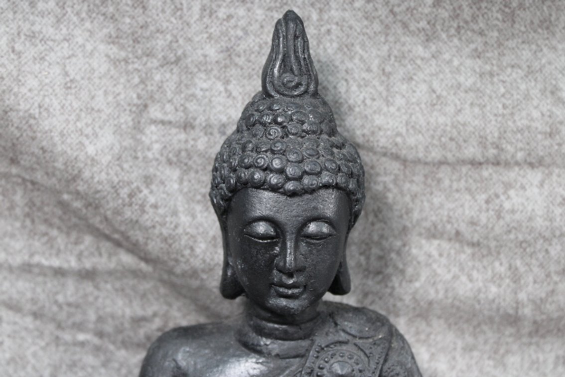 A Buddha statue measuring approximately 10 1/2" high by 8" wide