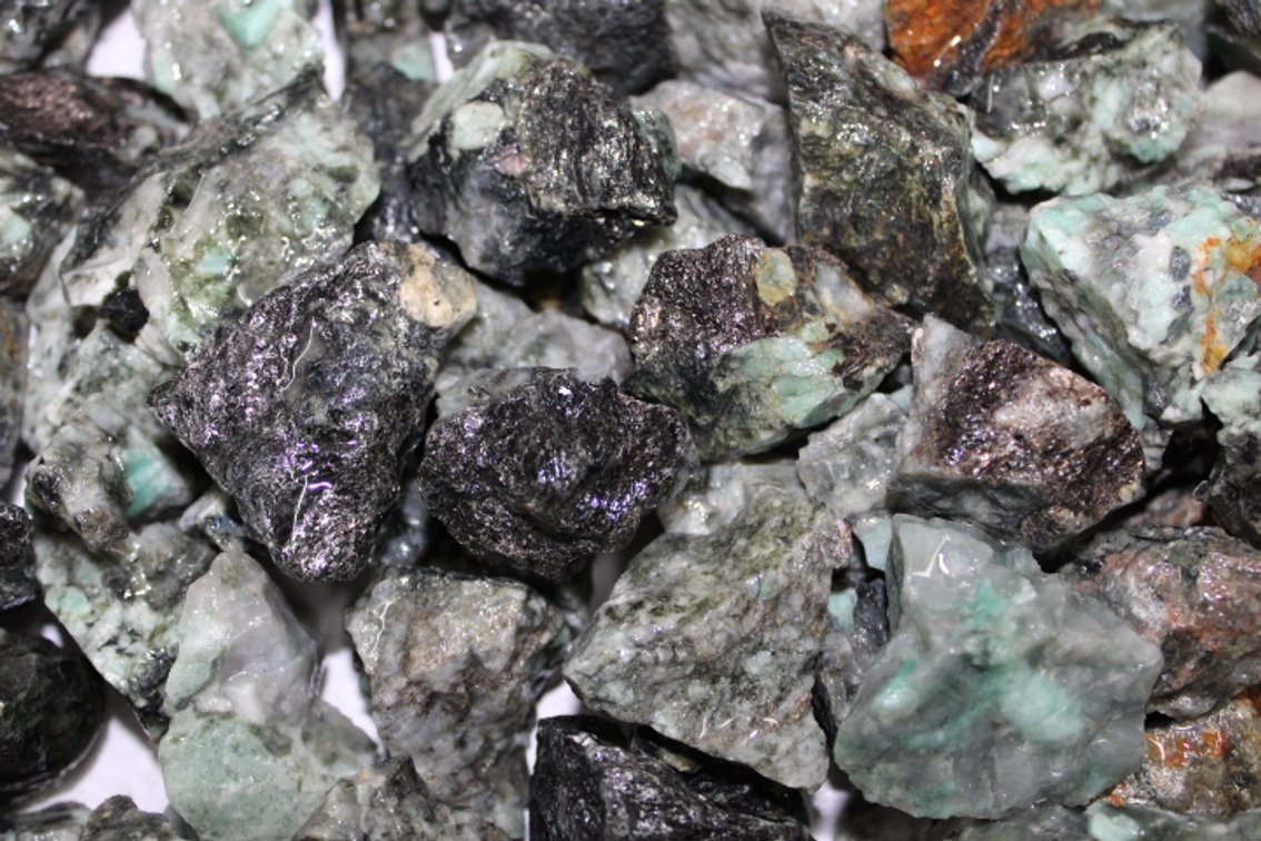 A 9 lb 8 oz flat of rough Emeralds