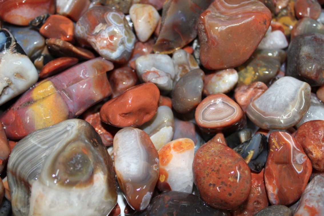 A 10 lb flat of Lake Superior Agate. The agates have gone through the first stage of tumbling giving them a satin look. They can be left as is or put back in the tumbler for a high polish