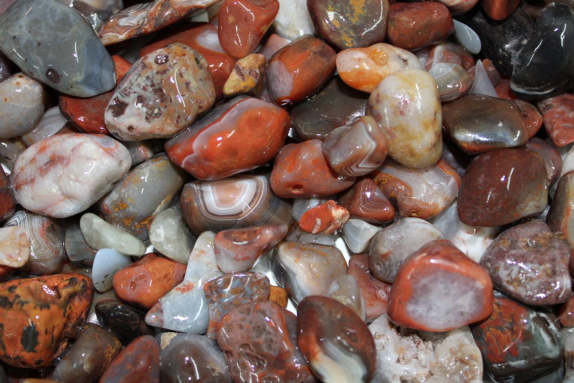 A 10 lb flat of Lake Superior Agate. The agates have gone through the first stage of tumbling giving them a satin look. They can be left as is or put back in the tumbler for a high polish