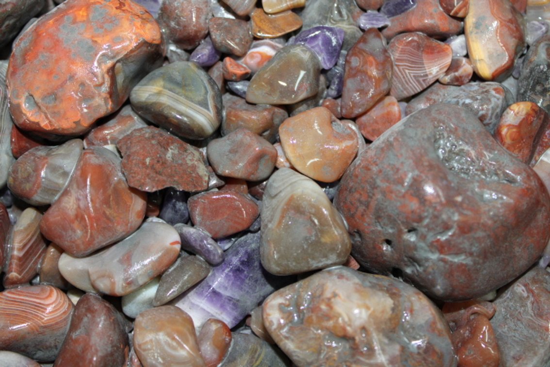 A 10 lb flat of mostly Lake Superior Agate. The agates have gone through the first stage of tumbling giving them a satin look. They can be left as is or put back in the tumbler for a high polish