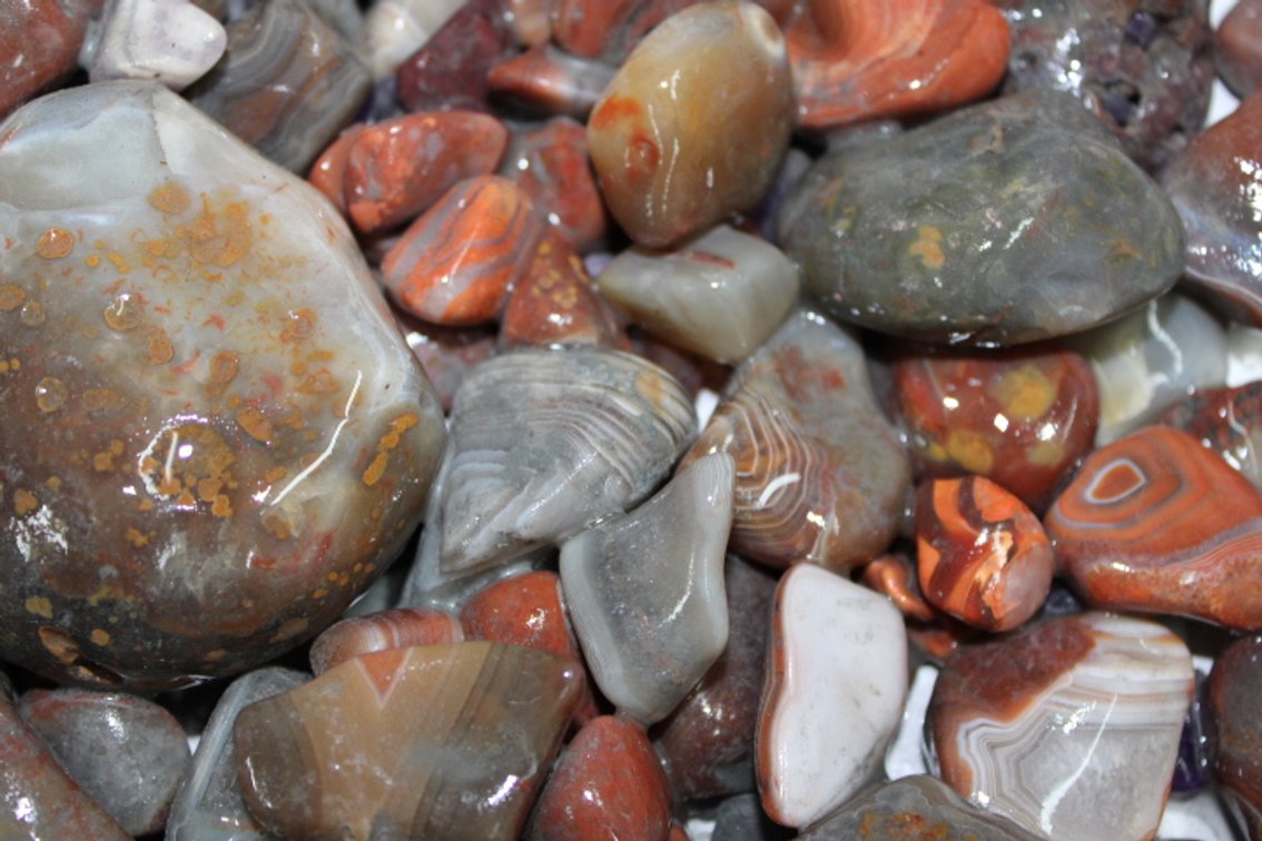 A 10 lb 5 oz flat of mostly Lake Superior Agates. The agates have gone through the first stage of tumbling giving them a satin finish. They can either be left as is or put back into the tumbler for a high polish