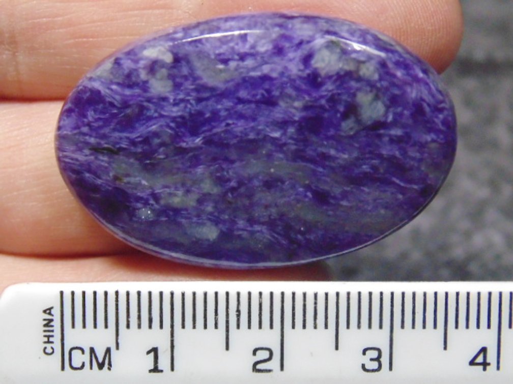 A oval Lepidolite cab, weighs 9.4 grams