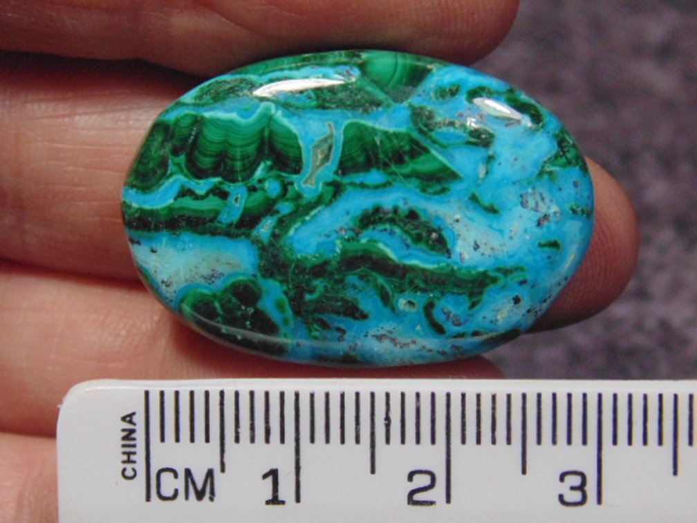 A oval Malachite/Chrysocolla cab, weighs 8.7 grams