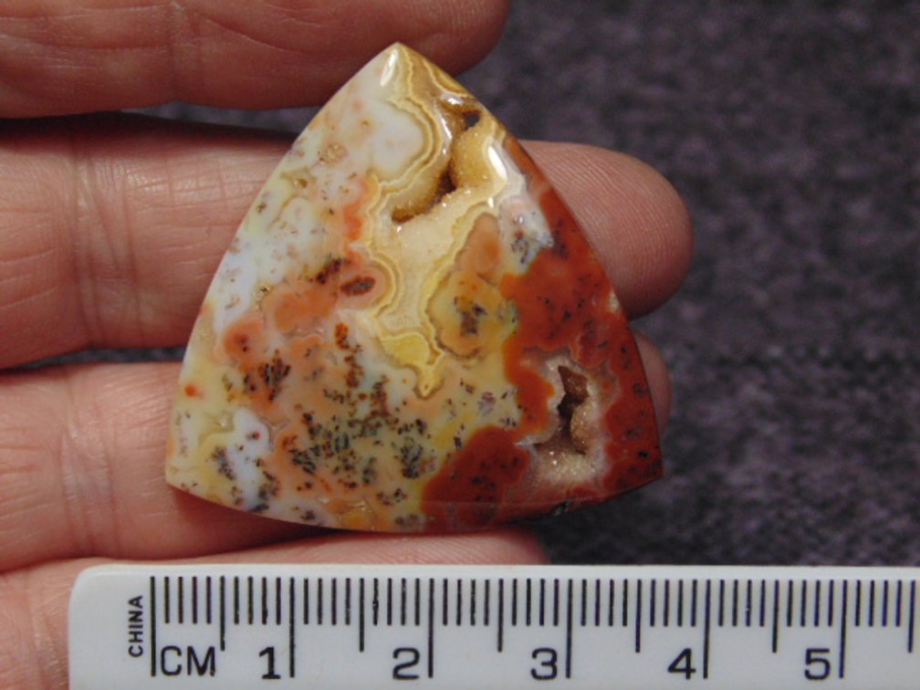 A triangle Agate cab, weighs 11.4 grams