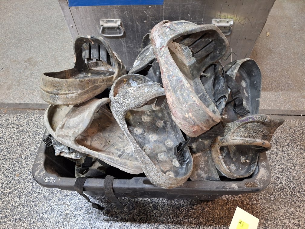Bin of Slip on Boots for Concrete Work