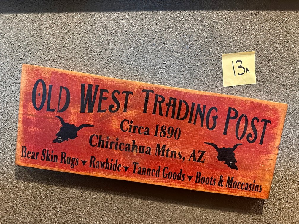 Old West Trading & Boots, Chaps & General Store & Free as the Wind signs