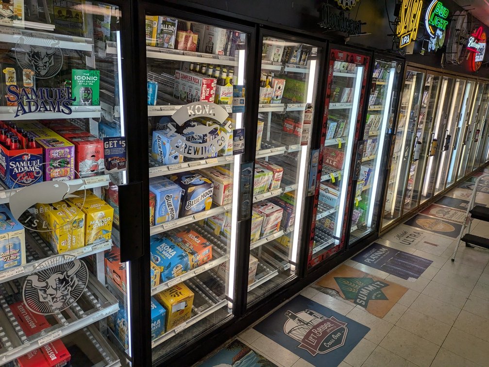 Retail Walk In Cooler, 10 Black Frame Glass Doors, 10 Gold Frame Glass Doors, Shelving Inside, Compressor on Top of Unit, 50'x12'x8'