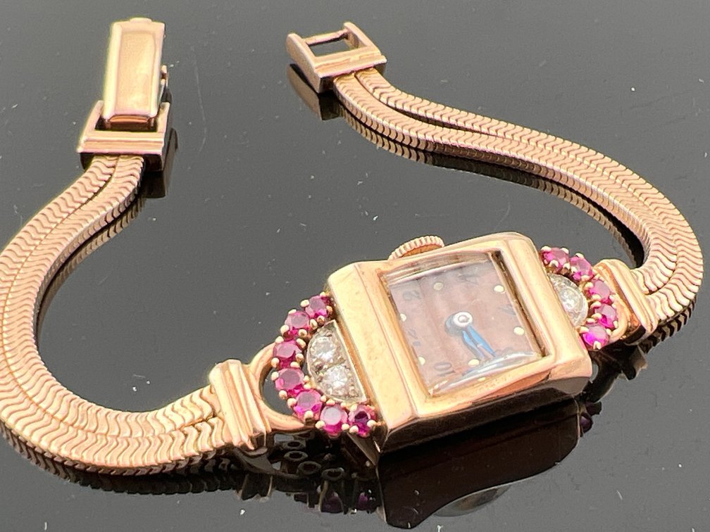 Ladies 14kt rose gold Stauffer Art Deco watch with diamond, ruby and gold band