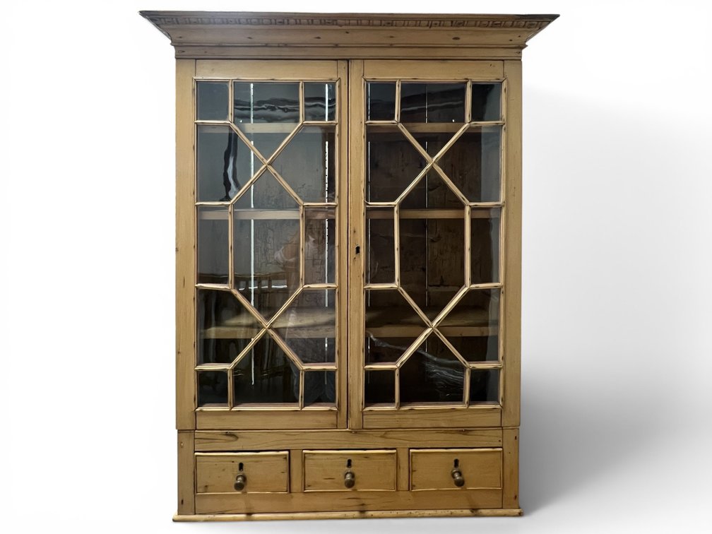 Stripped pine hanging cupboard with glass diamond paned doors