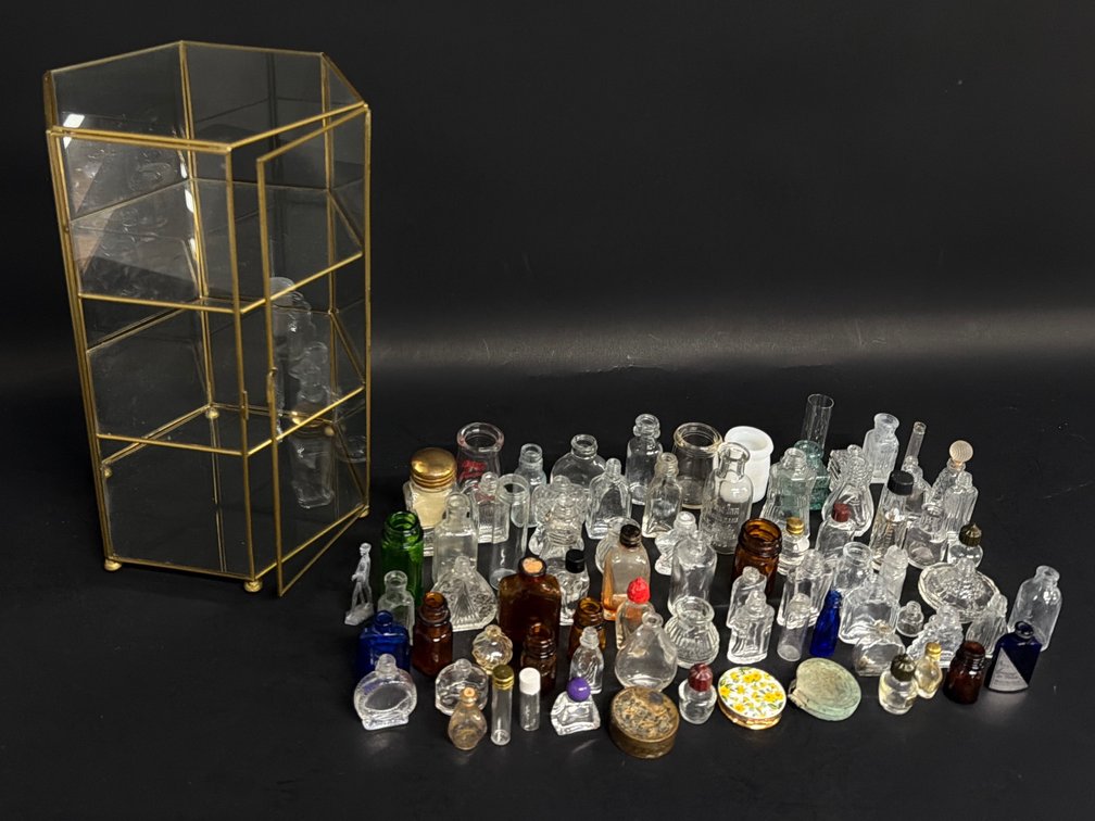 Glass display of miniature bottles